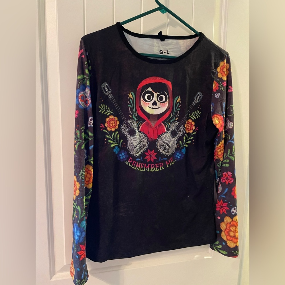 Black long sleeve Coco tee with Miguel on front and a guitar on the back